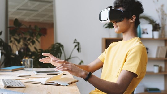 boy using a VR set to study at home